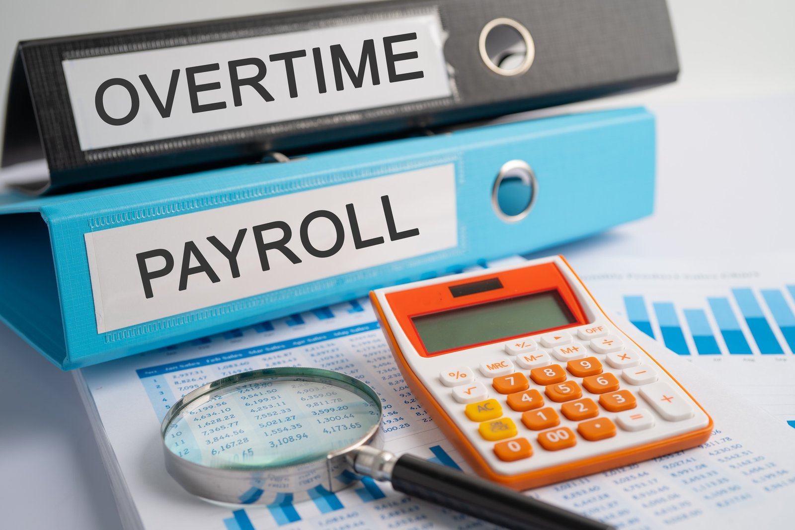 Overtime, Payroll. Binder data finance report business with graph analysis in office.