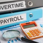 Overtime, Payroll. Binder data finance report business with graph analysis in office.